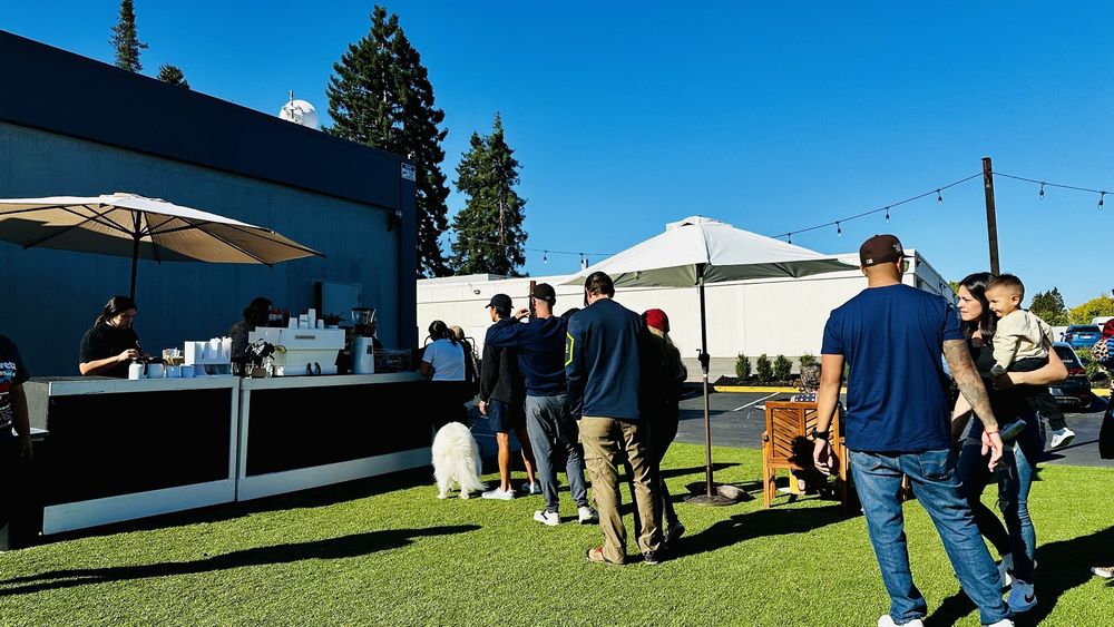Cowboy Coffee outdoor stand with crowd under sunny sky in Sunnyvale