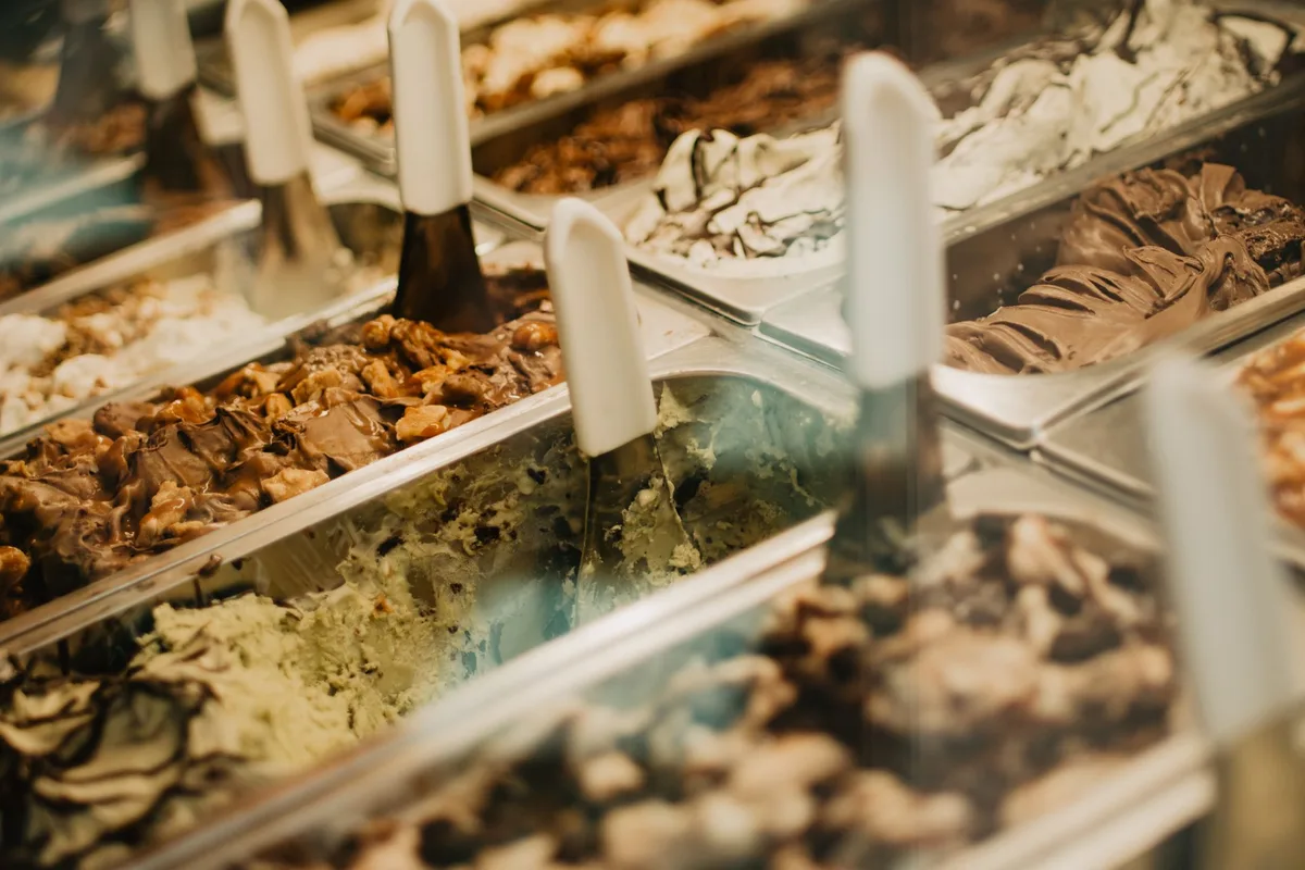 A display case of colorful gelato and Italian ice flavors