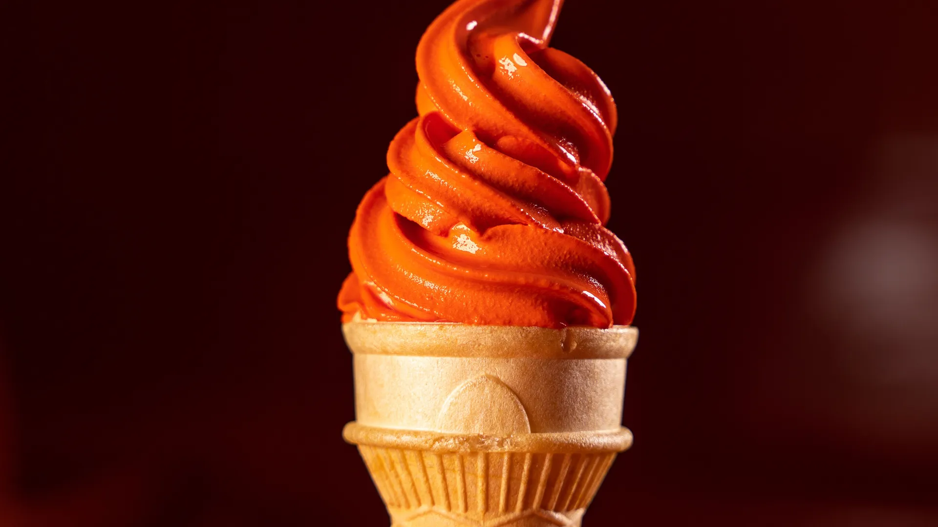 Soft serve Italian ice cream swirled high in a cone